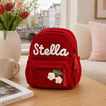 Personalisierter Cord-Rucksack in Rot mit Namen Stella und Blumen-Applikation